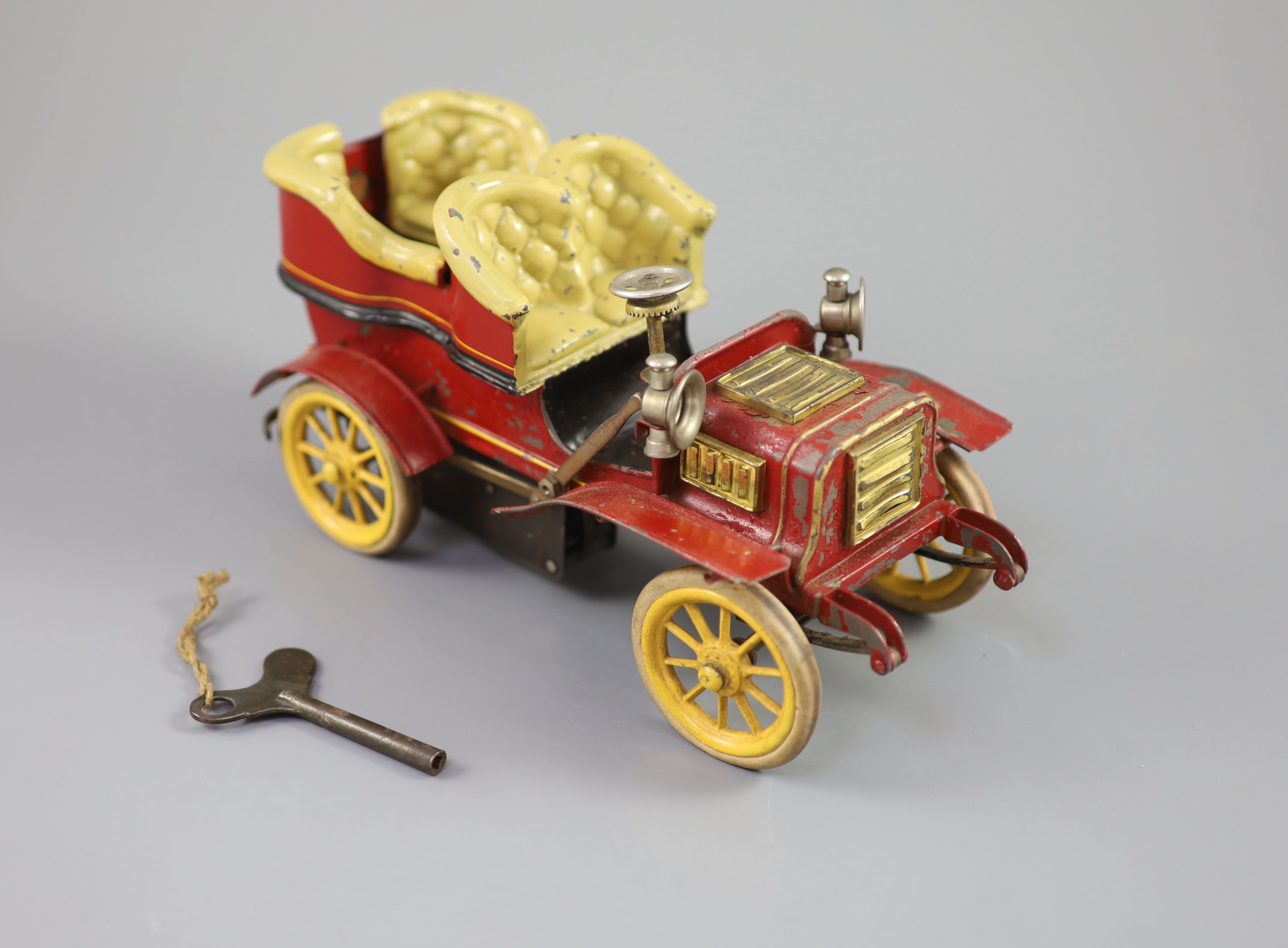 A Bing clockwork tinplate car, c.1906, length 9.5in. width 5in., with original card box and winding key